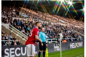 Help2Pay advertising boards beside the corner flag at a Premier League match